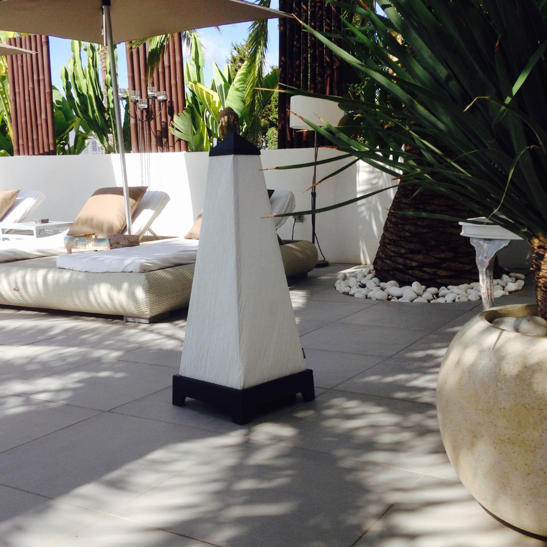 An XOUNTS Black sound system outside on a pool lounge